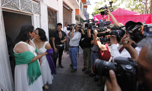 HISTORISK: Judith Vazquez (t.v) og Lol Kin Castaneda kysser foran pressen. Foto: AP Photo/Eduardo Verdugo/Scanpix