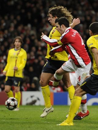 HER GIKK DET GALT: Cesc Fabregas viklet h�yrebeinet mellom beina p� Carles Puyol, og p�dro seg en brist i leggbeinet.Foto: SCANPIX/AP Photo/Tom Hevezi