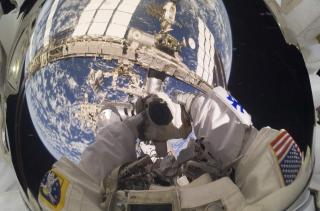TIDENES SELVPORTRETT: NASA-astronaut Garrett Reisman tar et selvportrett med jorda som speiles i visirglasset p� hjelpem. Foto: AP Photo/NASA/SCANPIX