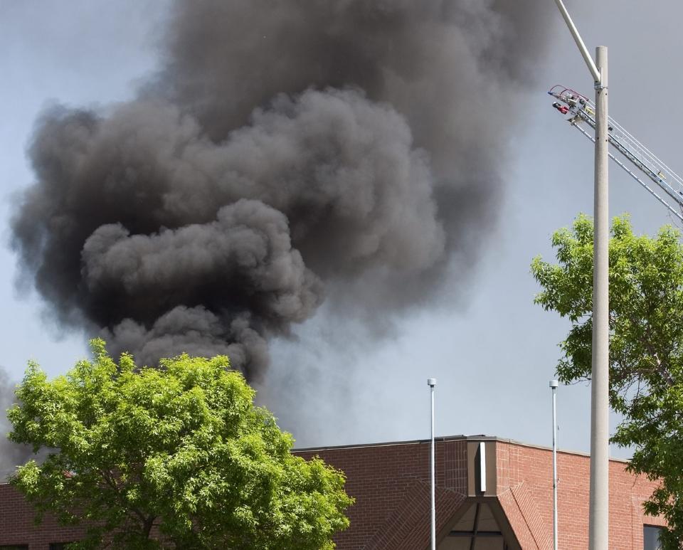 A firefighter runs in front of the Thinkway Toys Division building in Markam, Ontario after an aircraft crashed into the roof of the building on Tuesday, May 25, 2010. (AP Photo/The Canadian Press, Frank Gunn)
