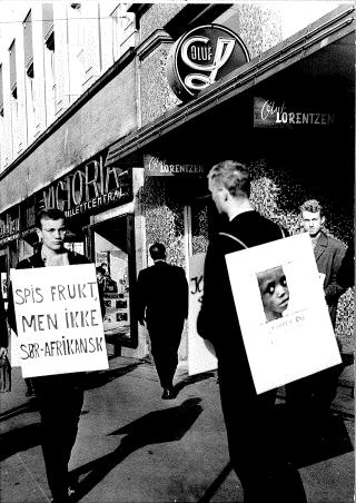 UPRAKTISK LANDNAVN: Men demonstrantene utenfor Oluf Lorentzen p� Karl Johan fikk det med p� plakaten i 1964. Foto: Dagbladet
