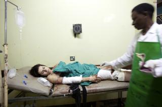 S�RET: En amerikansk kvinne ligger p� en sykeseng p� sykehuset Mulago i Ugandas hovedstad Kampala, etter bombeangrepet i g�r kveld. FOTO: AP Photo/Benedicte Desrus