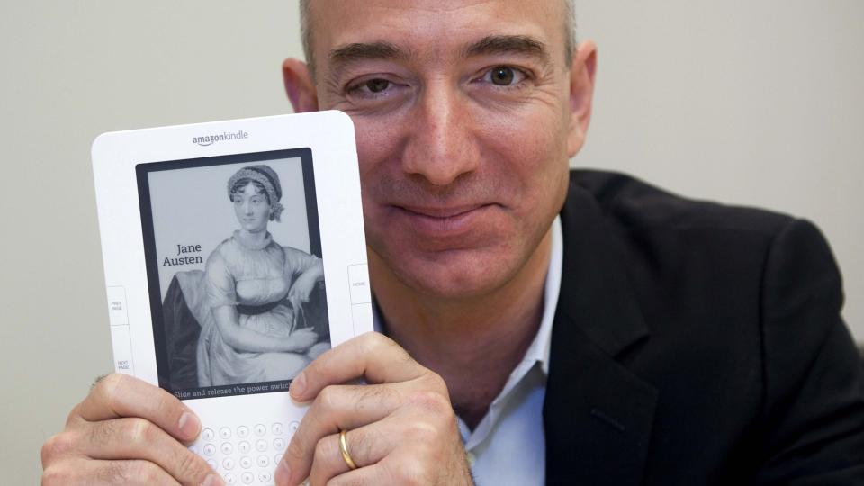 SUKSESS: Amazon-direkt�r Jeff Bezos med et Kindle-lesebrett i hendene. Lesebrettet har v�rt nettbokhandelens mest solgte produkt i to �r. For f�rste gang selger de n� ogs� flere b�ker til lesebrettet enn i innbundne utgaver. Foto: SCANPIX / REUTERS/Kim White