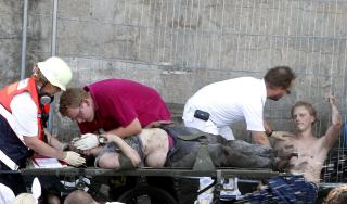 F�RSTEHJELP: Reddningsmannskaper gir f�rstehjelp til de mange som ble klemt i trengselen som oppsto. Foto: AP Photo/dapd/Hermann J. Knippertz/Scanpix