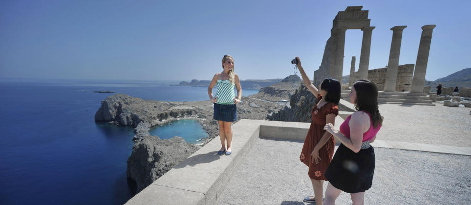  LINDOS:  Her er ruinene etter tempelet fra lindiske gudinnen Athene p� toppen av Lindos akropolis.   Fantastisk fint, sier jentene fra USA som fotograferer hverandre med den bl�  Paulus-bukta i bakgrunnen. Foto: JOHN TERJE PEDERSEN/Dagbladet