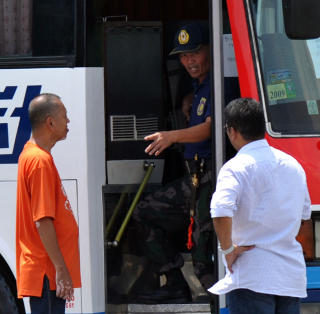 SENDTE INN FORHANDLERE: Her snakker gisseltakeren med forhandlerne foran bussen. Foto: AFP PHOTO/TED ALJIBE