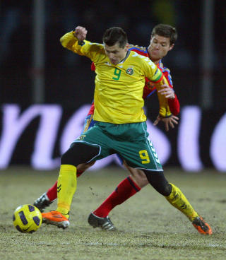 PROFILFATTIG: Litauens landslag best�r av helt ukjente navn og ansikter for det norske fotballpublikummet. Dette er landslagskaptein og tidenes toppscorer Tomas Danilevicius i duell med Spanias Xabi Alonso.Foto: SCANPIX / AFP PHOTO / PETRAS MALUKAS