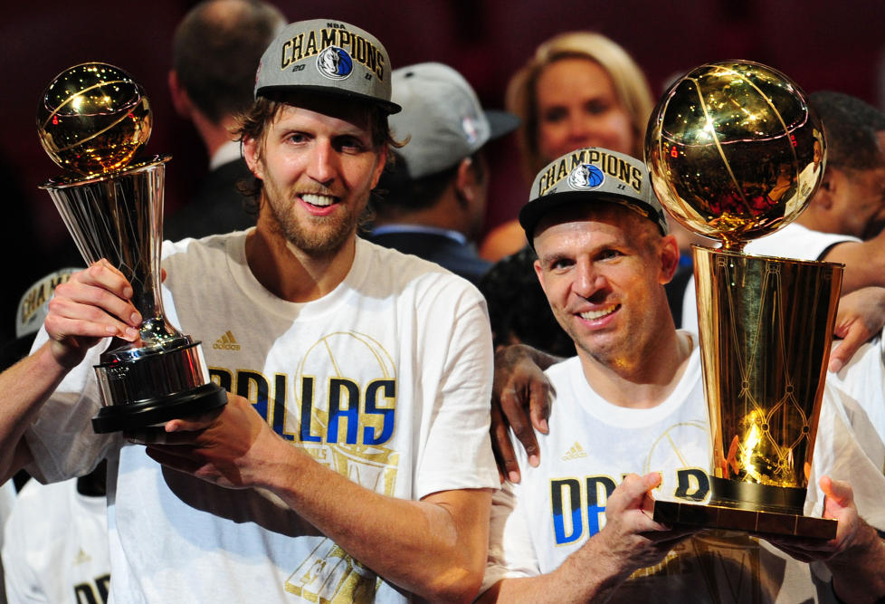Dirk Nowitzki (L) and Jason Kidd (R) of the Dallas Mavericks hold the MVP and Larry O'Brien Trophies after defeating the Miami Heat in Game Six of the 2011 NBA Finals, at the AmericanAirlines Arena in Miami, Florida on June 12, 2011.      AFP PHOTO/Mark RALSTON