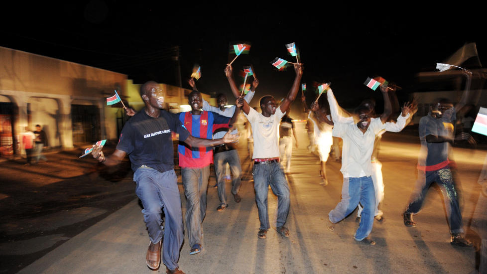 Residents of Juba in South Sudan dance in the streets as they celebrate the birth of their new nation on 09 July 2011.  South Sudan separated from Sudan to become the world's newest nation.                     AFP PHOTO/Roberto SCHMIDT