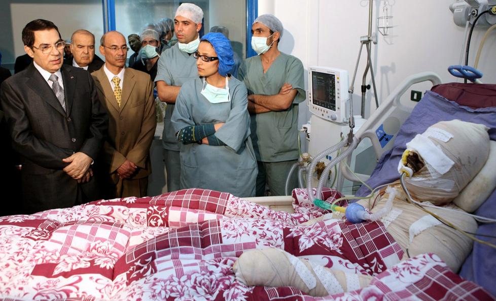 MARTYR: Mohamed Bouazizi helte bensin over seg selv og tente p�. Dette f�rte til at h�pet ble tent i den arabiske verden. Her f�r han �bes�k� av dav�rende Tunisia-president Zine al-Abidine Ben Ali p� sykehuset. Mohamed d�de seinere p� sykehus, presidenten flyktet og regimet falt. Foto: Stringer/EPA