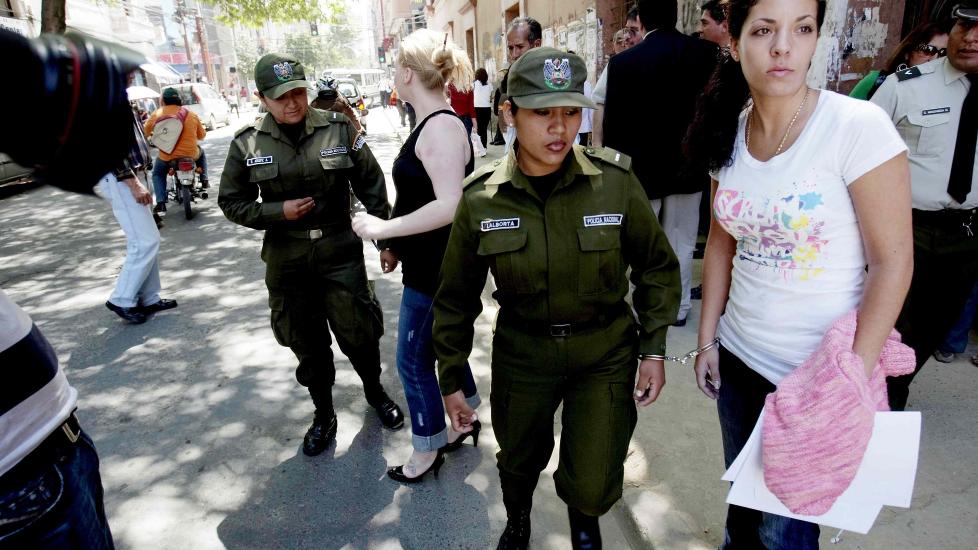 BOLIVIA: Madeleine Rodriguez (foran) og Stina Brendmo Hagen blir fraktet i h�ndgjern av politiet utenfor rettslokalene i Cochabamba der de to er siktetfor � ha fors�kt � smugle 22,4 kilo kokain til Norge. Foto: Stian Lysberg Solum / SCANPIX
