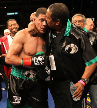 LOS ANGELES, CA - OCTOBER 15: Dewey Bozella gets a kiss form trainer Howard Mosley after defeating Larry Hopkins in their cruiserweight fight at Staples Center on October 15, 2011 in Los Angeles, California. Bozella won on a decision.   Stephen Dunn/Getty Images/AFP