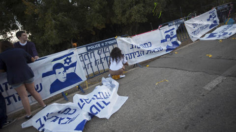 KLARE FOR FEIRING:  Israels ungdom henger opp plakater i n�rheten av huset til den kidnappede soldaten Gilad Shalit i morgentimene i dag. Familien bor nord i Israel, i Mitzpe Hila. Hvis Gilad Shalits form tillater det, vil han bli fl�yet hit med familien sin i l�pet av dagen. Ingen organisasjoner eller personer har f�tt ha kontakt med Shalit i l�pet av de dr�ye fem �rene i fangenskap. Foto: Foto: Oded Balilty/Ap/Scanpix