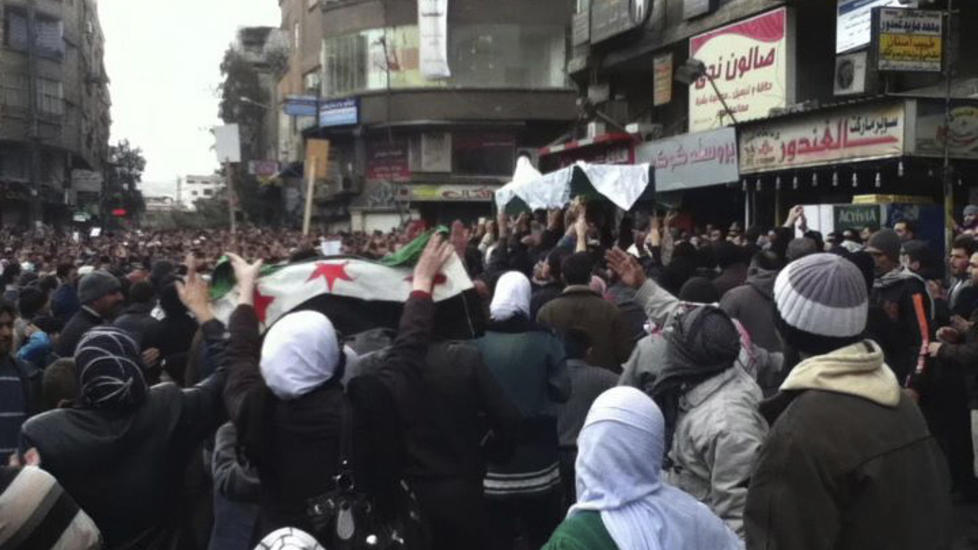 HEDRER SINE D�DE: Demonstranter b�rer kista til Muhammad Khaled Al-Kaheel, som de sier er blitt drept av regjeringsstyrker f�r begravelsen i Damascus i p� mandag. Foto: Reuters/Scanpix