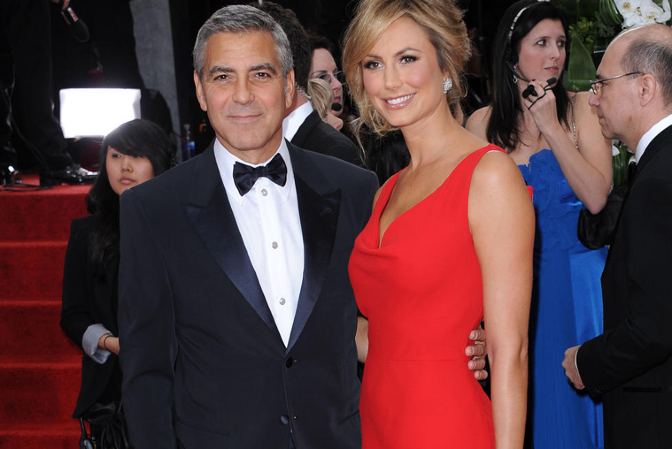 UTRO SOM BARN: George Clooney kalte seg selv utro som barn. Imidlertid misforsto han ordets betydning, han mente jo noe helt annet. Her med kj�resten Stacey Keibler. Foto: Stella Pictures