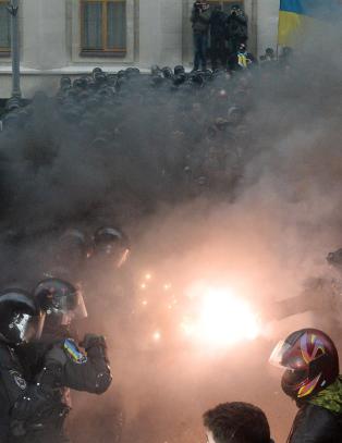 Tusenvis av demonstranter blokkerer inngangene til regjeringsbyggene i Kiev