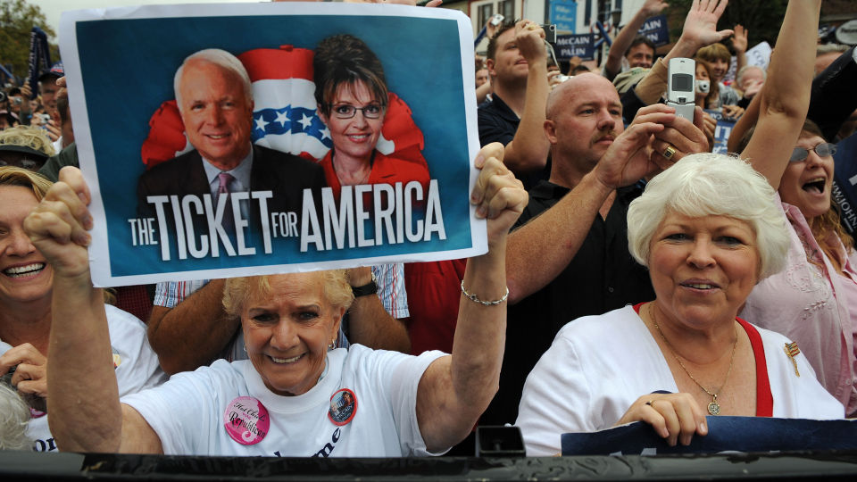 Supporters hold signs and cheer as US Republican presidential candidate Arizona Senator John McCain and his running mate Alaska Governor Sarah Palin visit the state at a ?McCain Street USA? campaign event in Lebanon, Ohio on September 9, 2008.   AFP PHOTO Robyn BECK