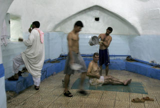 FLERE OG FLERE UTEND�RS: Irakiske menn slapper av ved det offentlige al Hashimi-badet i Najaf, som ligger 160 kilometer s�r for Bagdad. Foto: Alaa al-Marjani, AP