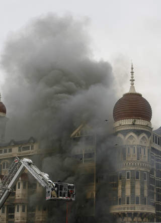 Firefighters douse a blaze at Taj Mahal Hotel in Mumbai November 29, 2008. Operations to dislodge militants at the Taj Mahal hotel in Mumbai ended on Saturday, security officials said, and at least three Islamist gunmen were killed.  REUTERS/Desmond Boylan (INDIA)