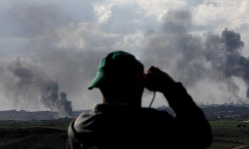 SER BOMBENE FALLE:  En israeler st�r og ser p� hva som skjer over Gaza den 9. januar i �r. Foto: Olivier Hoslet/Epa/Scanpix
