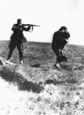 IVANGOROD, UKRAINA: En tysk soldat i ferd med � skyte en kvinne og hennes barn, 1942. Bildet ble sendt fra �stfronten til Tyskland, men stoppet av en polsk motstandsmann. P� bildet sto det Ukraina 1942, j�disk aksjon, Ivangorod. Foto: Yad Vashem Archives