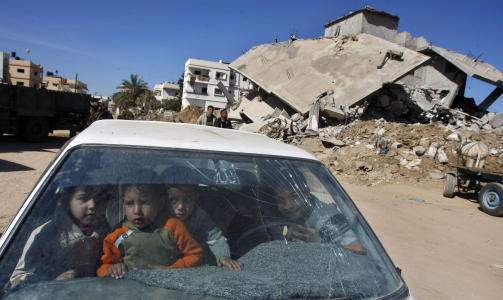 OMFATTENDE SKADE:  Den 22 dager lange krigen etterlot Gaza med betydelige merker. Her leker palestinske barn i en �delagt bil foran et av husene som ble truffet av bomber. Foto: AFP PHOTO/MAHMUD HAMS