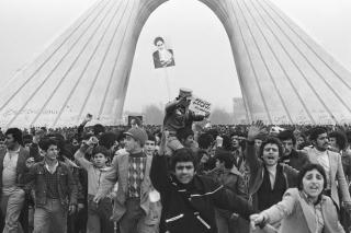 FEBRUAR 1979: St�ttespillerne til ayatollah Khomeini b�rer en soldat p� skuldrene. Foto: AP Photo/Aristotle Saris