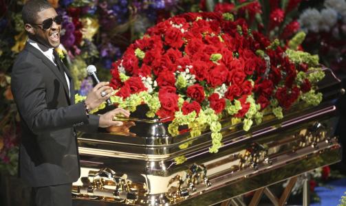  VED KISTA:  Usher opptrer foran Jacksons gullkledte kiste. Foto: REUTERS/Mario Anzuoni