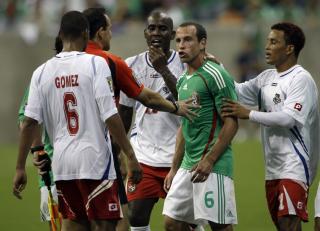 HISSIG: Mexicos Gerardo Torrado holdes igjen av en Panama-spiller. Foto: AP/David J. Phillip