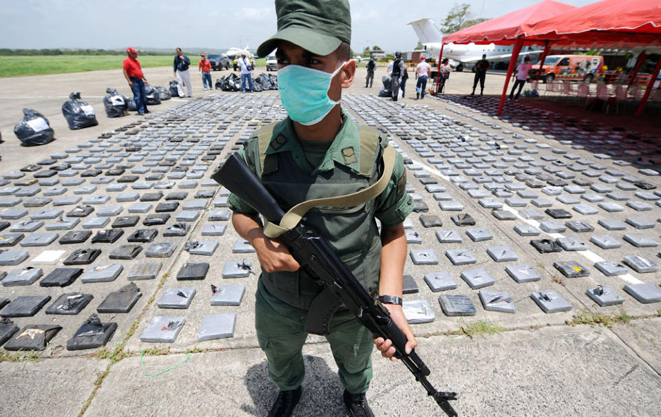 NARKOKRIG: En soldat fra den venezuelanske nasjonalgarden vokter et kokainbeslag p� til sammen to tonn i kystbyen Higuerote i mai. Trass slike storbeslag mener USA at Venezuelas myndigheter i praksis lar landet v�re et n�kkelland for kokainsmuglingen fra Colombia til resten av verden. Foto: JUAN BARRETO/AFP/SCANPIX