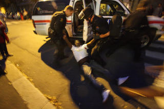 SKUTT: Det ble h�rt tre skudd i Jens Bjelkes gate p� T�yen i Oslo ca. klokka 22.20 i g�r. Her tar politiet h�nd om skuddofferet, som satt bl�dende i f�rersetet p� en r�d Opel. Fem minutter seinere ble en annen mann funnet skutt p� T�yen T-banestasjon i n�rheten. Foto: SVEIN GUSTAV WILHELMSEN
