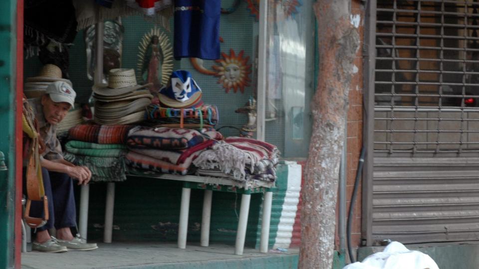  DAGLIGDAGS:  En kvinne ligger skutt og d�d under et laken p� et fortau i Juarez - Mexicos mest voldelige by. Mannen i fortausbutikken gj�r ikke en mine, dette er en dagligdags forteelse i Juraez. Denne drepte kvinnen ble funnet 28. juli. Foto: AP/SCANPIX.