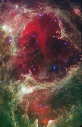 FARGERIKT: Spitzer-teleskopet tar for �vrig noen av de mest spektakul�re fotografiene fra verdensrommet. Her ser et st�vete omr�de i stjernebildet Cassiopeia, kalt W5, hvor det stadig dannes nye stjerner. Foto: AP Photo/NASA