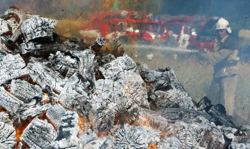 KJEMPET MOT FLAMMENE: En brannmann pr�ver � slukke flammene som oppsto etter at lageret fylt med fyrverkeri gikk i lufta. Foto: AFP PHOTO / ALEXANDER KHUDOTEPLY / Str