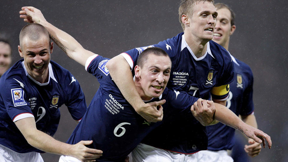JAKTER P� VM-BILLETT: Darren Fletcher tar et godt tak rundt l�rdagens m�lscorer Scott Brown. Onsdag skal skottene pr�ve � f� overtaket mot Nederland. Foto: AFP
