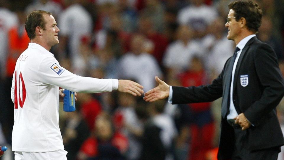 England's manager Fabio Capello (R) shakes hands with Wayne Rooney after their World Cup 2010 qualifying soccer match against Croatia at Wembley Stadium, in London September 9, 2009.    REUTERS/Eddie Keogh (BRITAIN SPORT SOCCER)
