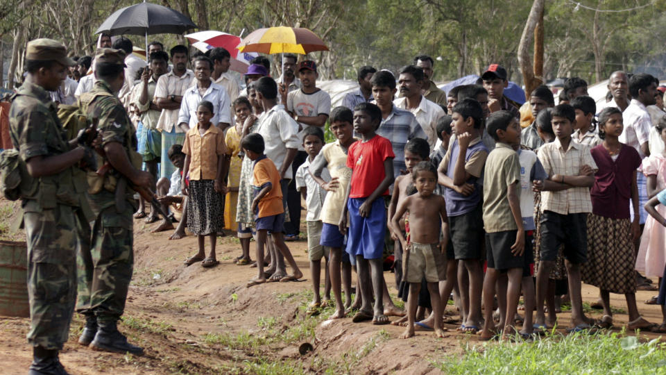BEKYMRET: Srilankiske soldater holder vakt ved en interneringsleir for tamiler. Minst 136.000 tamiler skal slippes fri innen utgangen av m�neden. Foto: REUTERS/SCANPIX
