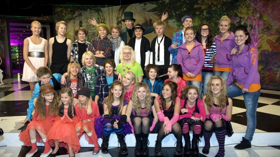 MGP JR 2009: I morgen kveld blir det avgjort hvem som vinner. Her er alle �rets MGP jr-artistene samlet p� ett brett. P� den midterste raden fra midten og til venstre ser vi de norske artistene Mystery og helt til venste, J�rgen Dahl Moe. I midten bak med flosshatt, programleder Ola Lindholm. Foto: Anders Gr�nneberg