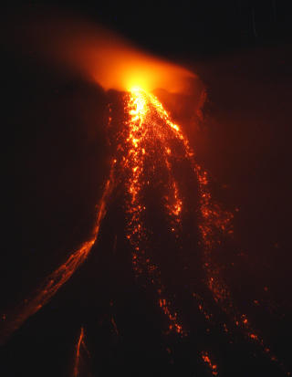 �KENDE AKTIVITET: S�rlig nattestid kan man se hvordan lava str�mmer nedover fjellsidene p� vulkanen Mayon p� Filippinene. S�ndag �kte aktiviteten betydelig. Foto: Reuters