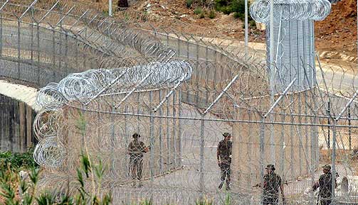 FESTNING EUROPA: Spanske soldater patruljerer gjerdet som skiller Europa fra Afrika i den spanske enklaven Ceuta p� det marokkanske fastlandet. De siste ukene har 11 flyktninger blitt drept og mange flere skadet i fors�kene p� � ta seg inn i Europa via enklavene.