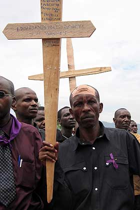 RWANDA: En overlevende b�rer et kors som skal plasseres p� gravene til noen av de drepte tolv �r etter folkemordet.  I verste fall kan demoniseringen av andre etniske grupper f�re til tragedier som den i Rwanda.