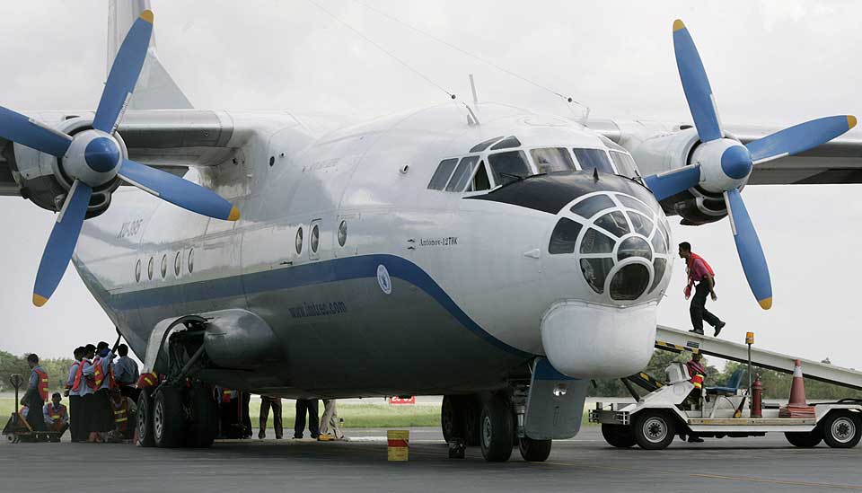 SLITER MED � F� FRAM HJELPEN: Kambodsjanske arbeidere laster et fly med matvarer som skal til Burma.