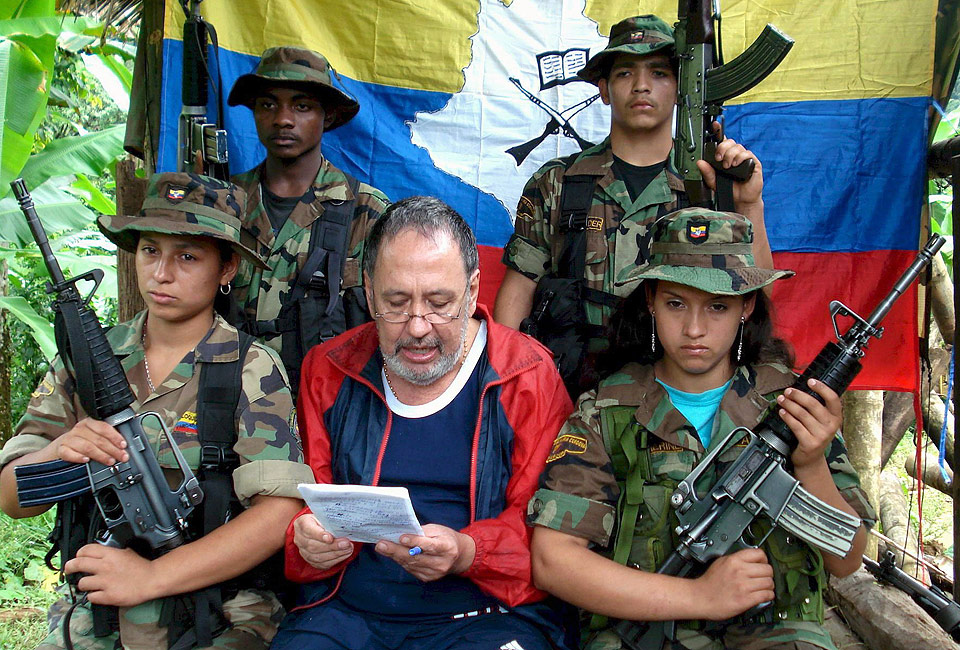  APRIL 2008:  Oscar Lizcanos familie fikk dette bildet i april i �r av fangen som leser opp en appell omgitt av geriljasoldater og med FARC-flagget i bakgrunnen.